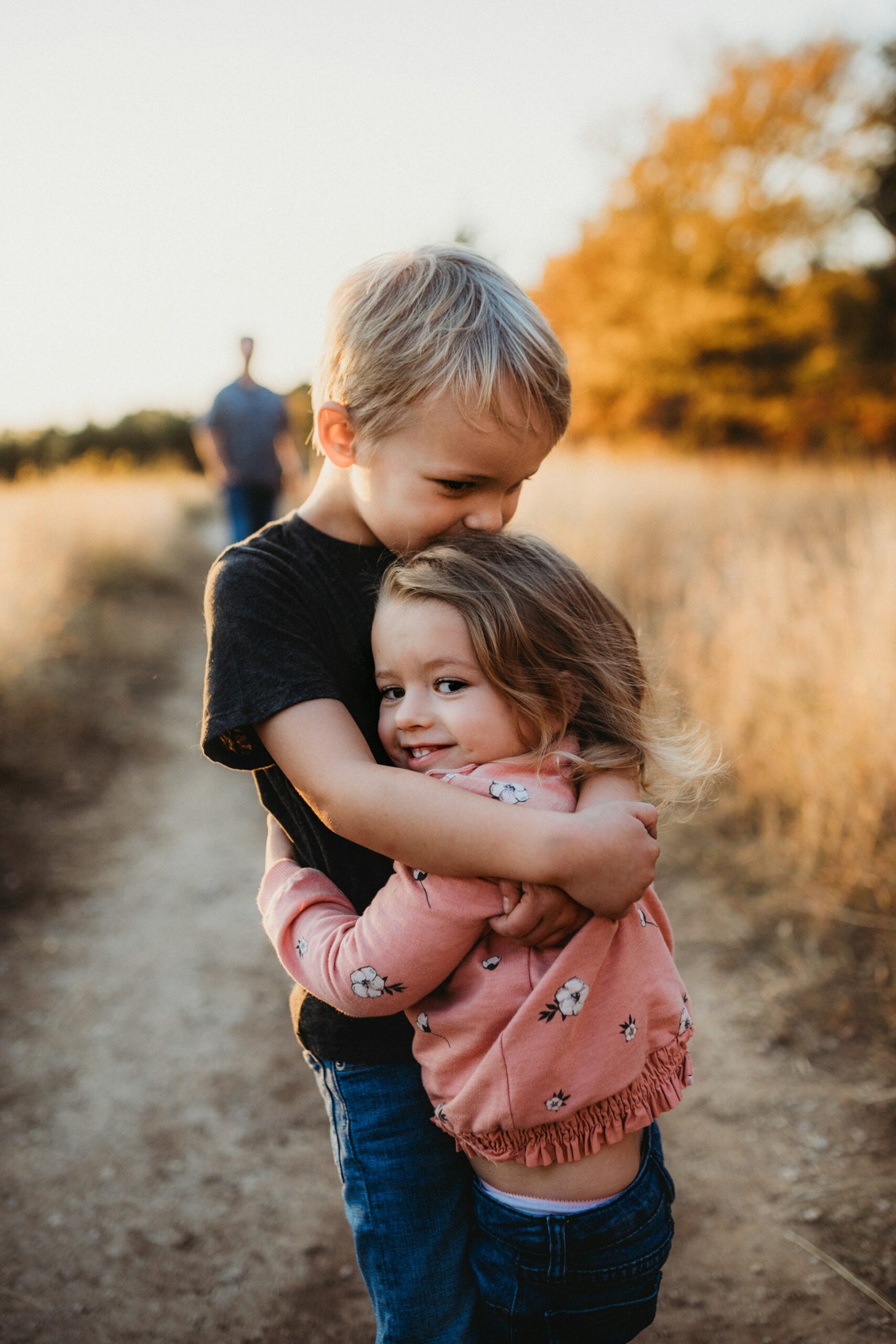 A brother hugging his sister