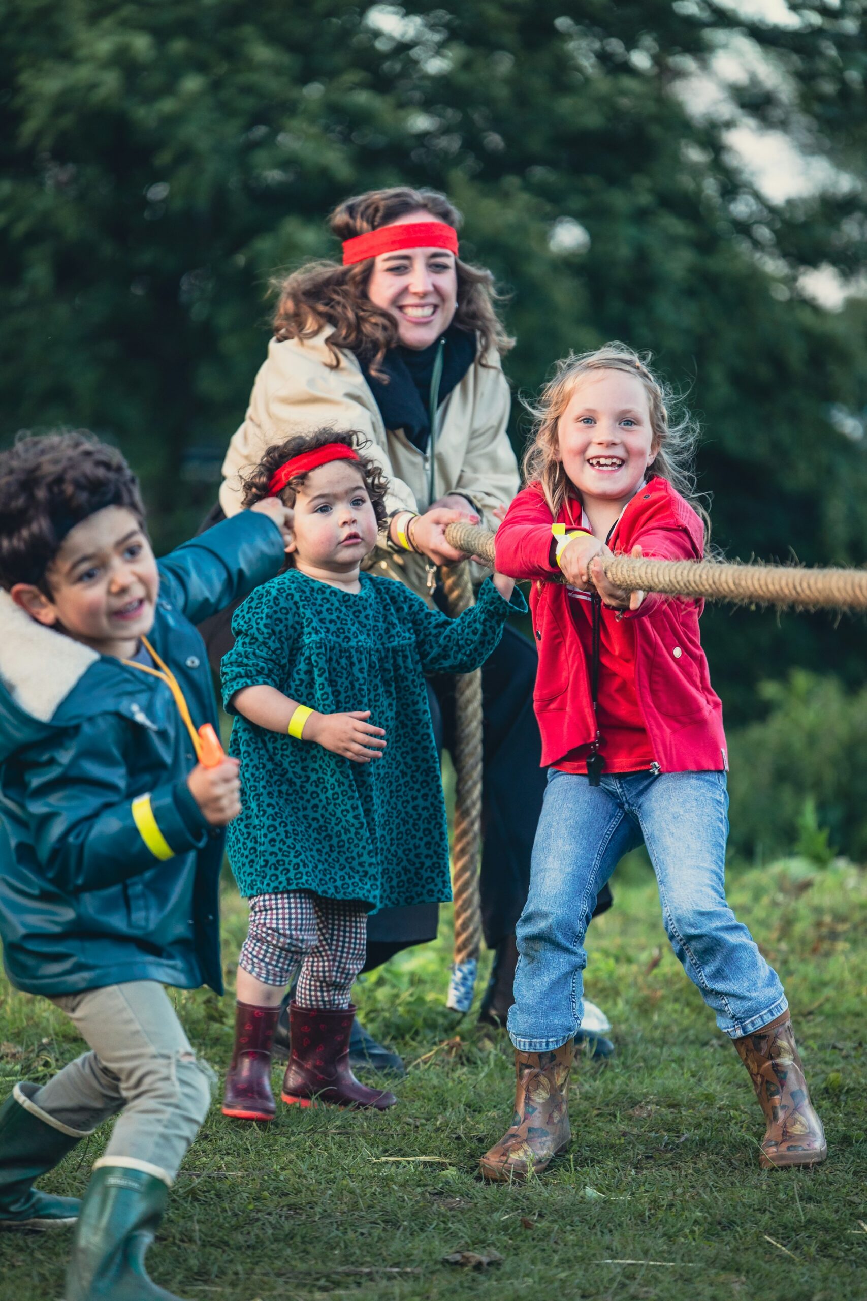 A women with kids playing tug of war