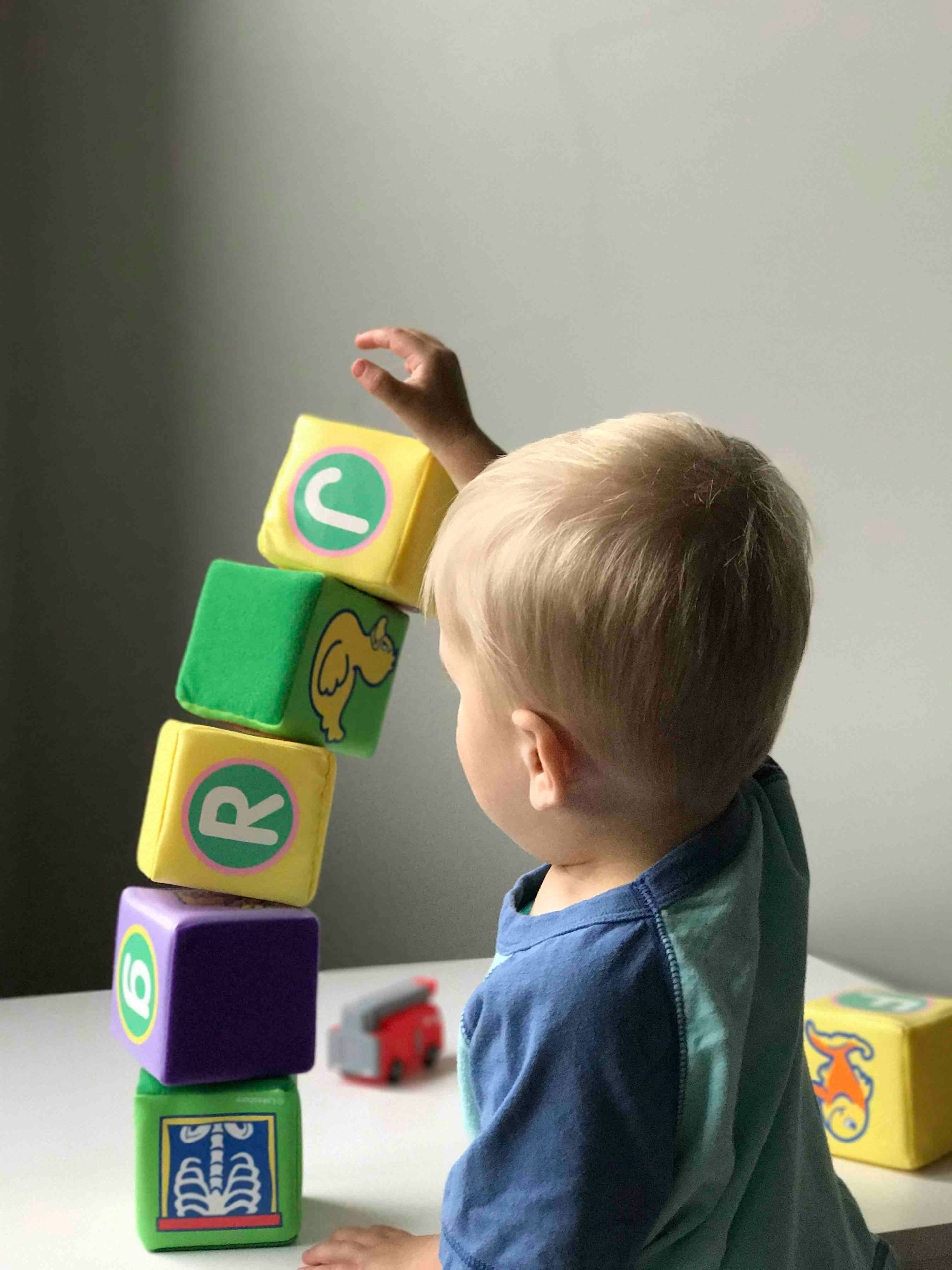 A young boy stacking blocks